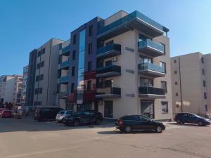 a parking lot with cars parked in front of a building at 4 RENT - Apt 3 camere in Constanţa