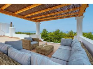 a large blue couch sitting on a patio at Villa Pinomar by Interhome in Colonia de Sant Pere