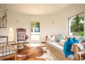 a living room with a couch and a chair at Villa Pinomar by Interhome in Colonia de Sant Pere +31 photos