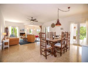 a dining room and living room with a table and chairs at Villa Pinomar by Interhome in Colonia de Sant Pere