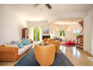 a living room with wicker chairs and a couch at Villa Pinomar by Interhome in Colonia de Sant Pere