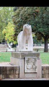 a statue of a lion standing in a park at Le Duché - Séjour romantique avec balnéo privative - Dijon centre in Dijon