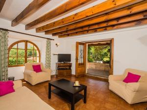 a living room with two couches and a table at Holiday Home Cuxach d'en Joan by Interhome in Pollença