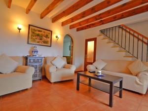 a living room with two couches and a table at Holiday Home Cuxach d'en Joan by Interhome in Pollença