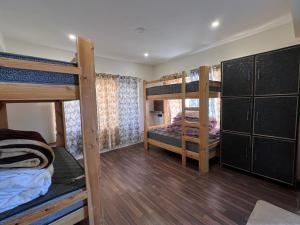a room with four bunk beds in it at De katong in Leh