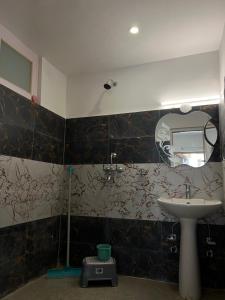 a bathroom with a sink and a mirror at De katong in Leh