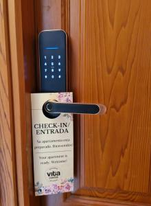 a remote control sticking out of a door at Apartamentos VITA CENTER in Granada