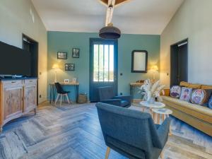 a living room with a couch and a table at Holiday Home La Cabane Andernosienne by Interhome in Andernos-les-Bains +20 photos