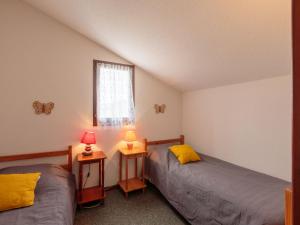 two beds in a room with two lamps at Holiday Home Les Charmilles-10 by Interhome in Les Mathes