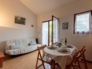 a living room with a table and a couch at Holiday Home Les Charmilles-10 by Interhome in Les Mathes