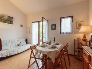 a living room with a table and a couch at Holiday Home Les Charmilles-10 by Interhome in Les Mathes +27 photos
