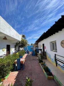 a house with a pathway between two buildings at Dahab Days Hostel in Dahab
