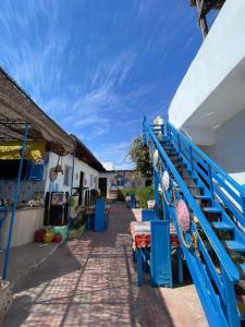 a blue staircase leading up to a building with a table at Dahab Days Hostel in Dahab