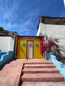 a yellow door with a painting on the side of a house at Dahab Days Hostel in Dahab