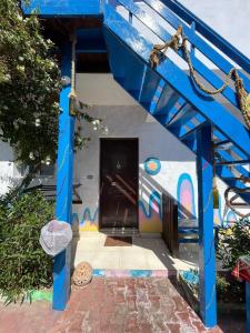a blue house with a painting on the side of it at Dahab Days Hostel in Dahab +1 photo