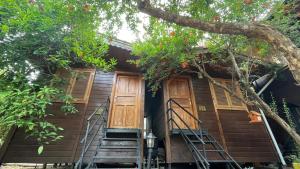 a house with stairs leading up to the door at Olympos Varuna Bungalows in Olympos