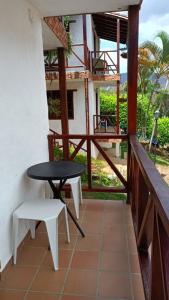 a balcony with a table and a table and chairs at Hotel Verano Resort San Gil in San Gil