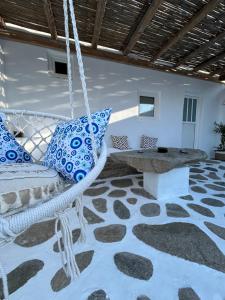 a room with a swinging bed and a table at Louloudasrooms Studio in Molos Parou +1 photo