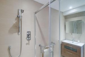 a bathroom with a shower and a sink at Charming Reigate Redhill Cottage in Reigate +28 photos