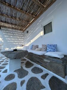 a room with a bed with a table and a window at Louloudasrooms Studio in Molos Parou