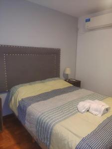 a bedroom with a bed with two towels on it at Nueva Cordoba Funcional in Cordoba