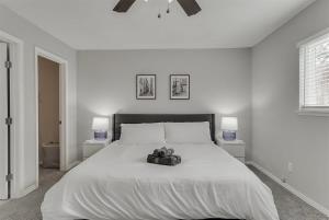 a white bedroom with a large bed with two night stands at Open Space Home for Family Groups with Privat Pool in Garland +27 photos