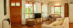 ein Wohnzimmer mit Sofa und Fernseher in der Unterkunft La Casita del Bosque in San Martín de los Andes