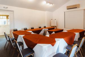 a conference room with tables and chairs and a whiteboard at Hotel Ciudad Vieja in Guatemala