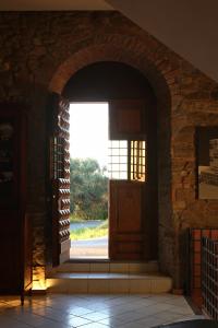 una entrada a un edificio con una puerta abierta en Madonna Del Poggio CAV, en Scarlino