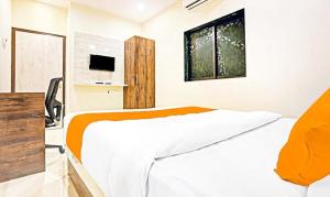 a bedroom with a white bed and a window at Tavakkal Hotel Near Bandra Kurla Mumbai in Mumbai
