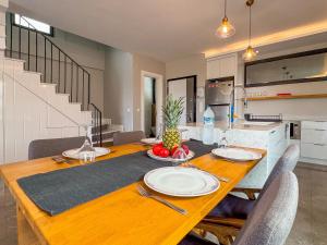 a wooden table with plates and fruit on it in a kitchen at Villa Elite in Kusadası