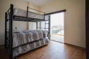 a bedroom with two bunk beds and a balcony at New Family-Friendly Poolside Escape in Pazulco +32 photos