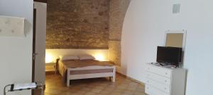 Ένα ή περισσότερα κρεβάτια σε δωμάτιο στο Masseria Baglio Perciata