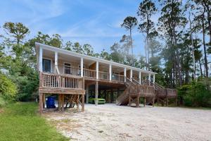 a large house with two decks on the beach at Beach Cottage West in Dauphin Island