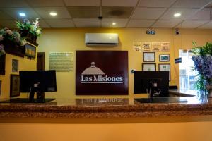een bar met twee wastafels en een bord waarop staat dat we fouten maken bij Hotel Las Misiones in Monclova