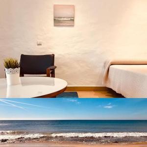 a room with a bed and a room with the ocean at Apartamentos Borda D´Agua in Albufeira