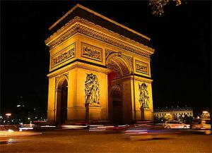 a large building is lit up at night at Hôtel Du Bois Champs-Elysées in Paris