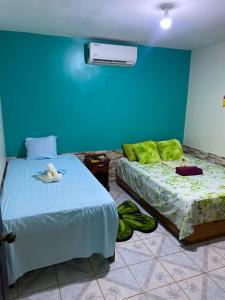 Кровать или кровати в номере Cabinas Mitchaelle's