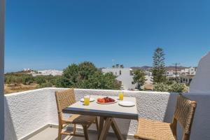 a table with a plate of food on a balcony at Pergola in Pollonia
