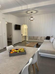 a living room with a bowl of fruit on a table at Sklavadi Vineyard House in Kamari