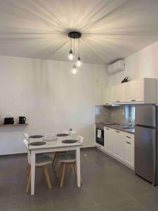 a kitchen with a table and chairs in a room at Sklavadi Vineyard House in Kamari