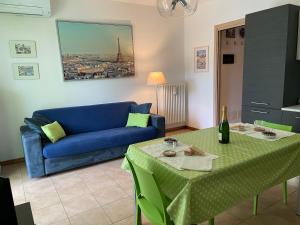 a living room with a blue couch and a table at Casa Manzoni in Lenno