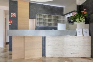a reception desk in a lobby with wood at Hotel Continental in Caorle