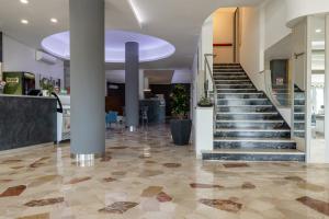 a lobby with a staircase in a building at Hotel Continental in Caorle