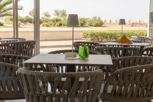 a group of tables and chairs in a restaurant at Hotel Continental in Caorle