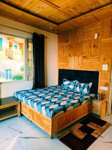a bedroom with a large wooden bed in a room at COZY HEAVEN HOME STAY DALHOUSIE-Near Fortune Park ITC Karelanu in Dalhousie