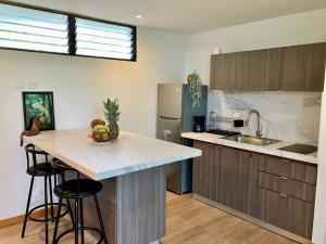 a kitchen with a island in the middle of a room at Casa Eden in Tamarindo