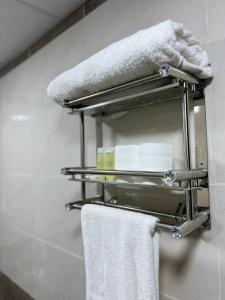 a towel rack in a bathroom with towels at Golden Gate Luxury Camp in Wadi Rum +79 photos