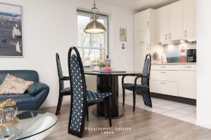 a kitchen and dining room with a table and chairs at Fewo 4 Knotenpunkt in Laboe