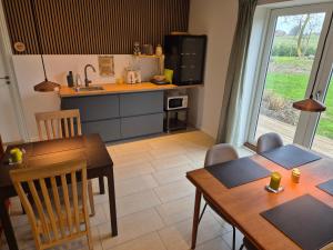 a kitchen and dining room with a table and chairs at Mols Bed & Breakfast in Knebel +11 photos